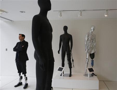 Professor Hugh Herr, who heads the Biomechatronics research group at the MIT Media Lab, stands amid mannequins displaying various bionic limbs his lab has developed at the Massachusetts Institute of Technology in Cambridge, Massachusetts April 4, 2014. REUTERS/Brian Snyder