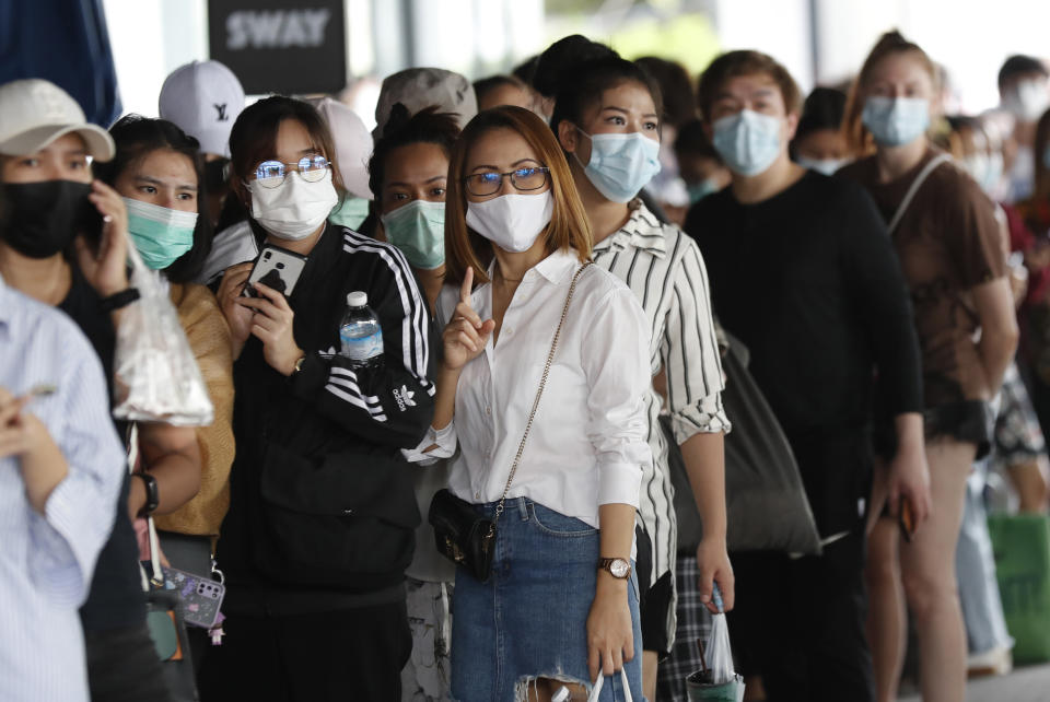 Workers in a local entertainment venue area line up for the coronavirus test in Bangkok, Thailand, Thursday, April 8, 2021. Thailand has confirmed its first local cases of the coronavirus variant first detected in the U.K., raising the likelihood that it is facing a new wave of the pandemic, a senior doctor said Wednesday. (AP Photo/Sakchai Lalit)
