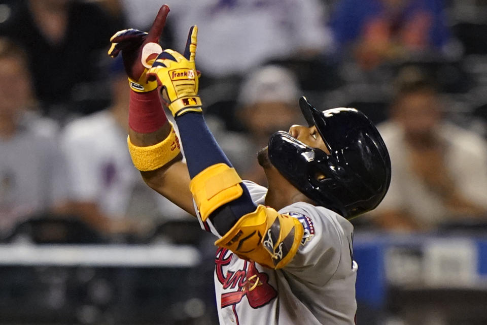 Atlanta Braves' Ronald Acuña Jr. points skyward as he crosses the plate after hitting a solo home run during the fifth inning of the second baseball game of a doubleheader against the New York Mets, Monday, June 21, 2021, in New York. (AP Photo/Kathy Willens)