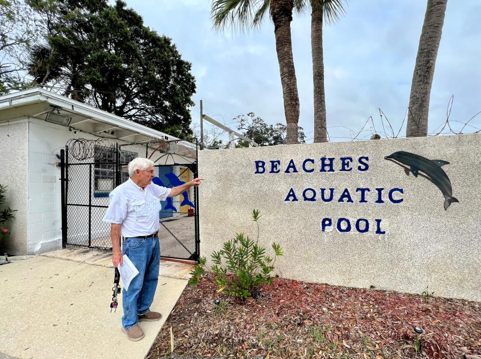 Bill Williams points out the entrance sign he painted at Beaches Aquatic Center in Atlantic Beach. The pool is celebrating its 60th year with an old-timers meet on Saturday, Oct. 7. Williams and his wife, June, have been involved with the facility since the 1970s.