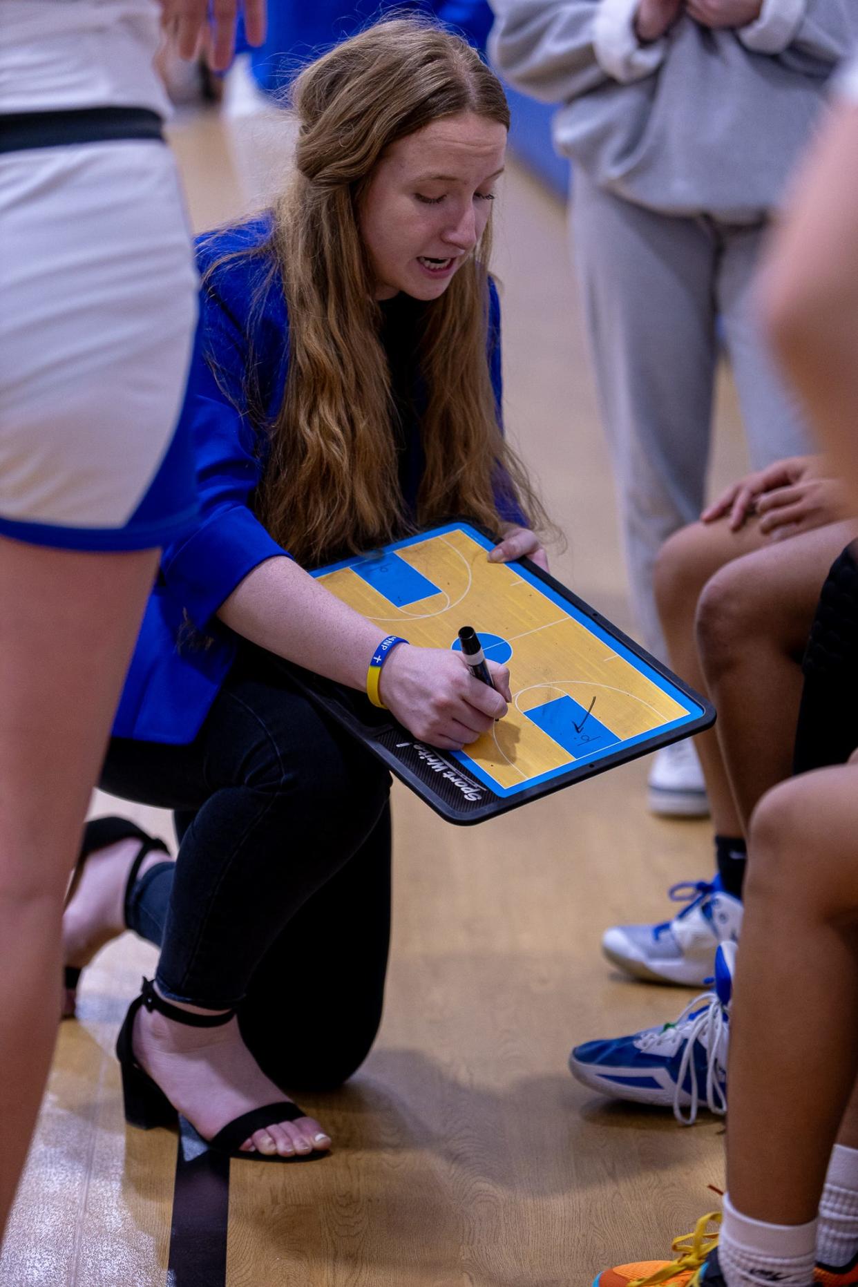 Great Lakes coach Katy Shannon draws up a play during a timeout.