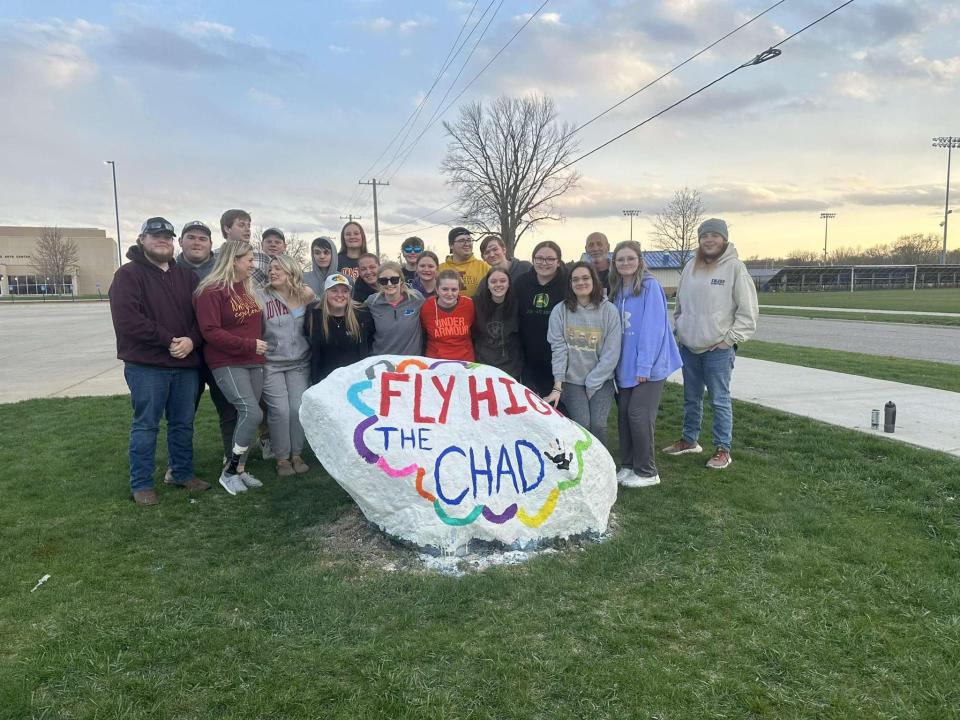 Current and former students painted a rock in memory of their teacher Chad Morman, who died in a crash Sunday.