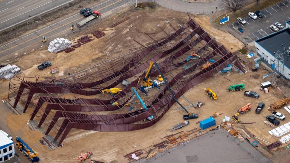 This aerial photo looking southwest shows the wreckage in center with cars traveling on Interstate 84 at top left. The corner of the Firehawk Helicopters building is at bottom left, and the Jackson Jet Center is at right. City of Boise