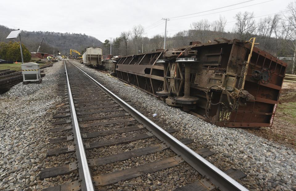 Overturned train cars rest along the tracks at the site of the train derailment at the intersection of the tracks with Apison Pike on Wednesday, Dec. 21, 2022. The driver of a semi-truck involved in the derailment has been charged. News outlets reported on Wednesday, Jan. 11, 2023 that Collegedale Police arrested the driver and charged him with failure to yield, a registration violation and felony reckless endangerment. (Matt Hamilton/Chattanooga Times Free Press via AP)