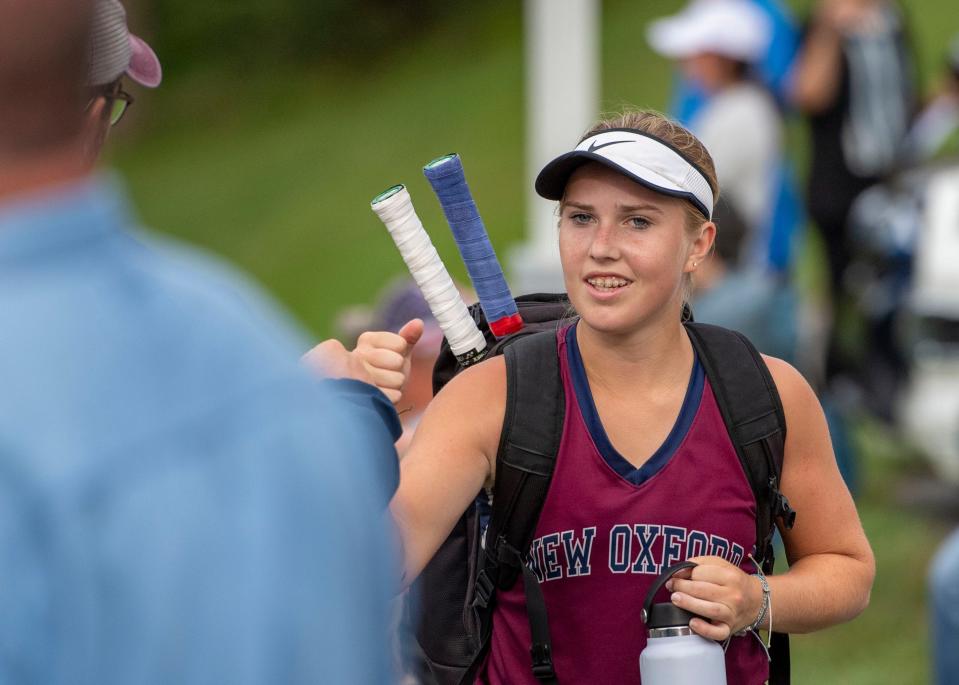 New Oxford's Anya Rosenbach gets a fist bump after winning her No. 1 singles match 6-0, 6-1 on Friday, Sept. 22, 2023 at Dallastown.