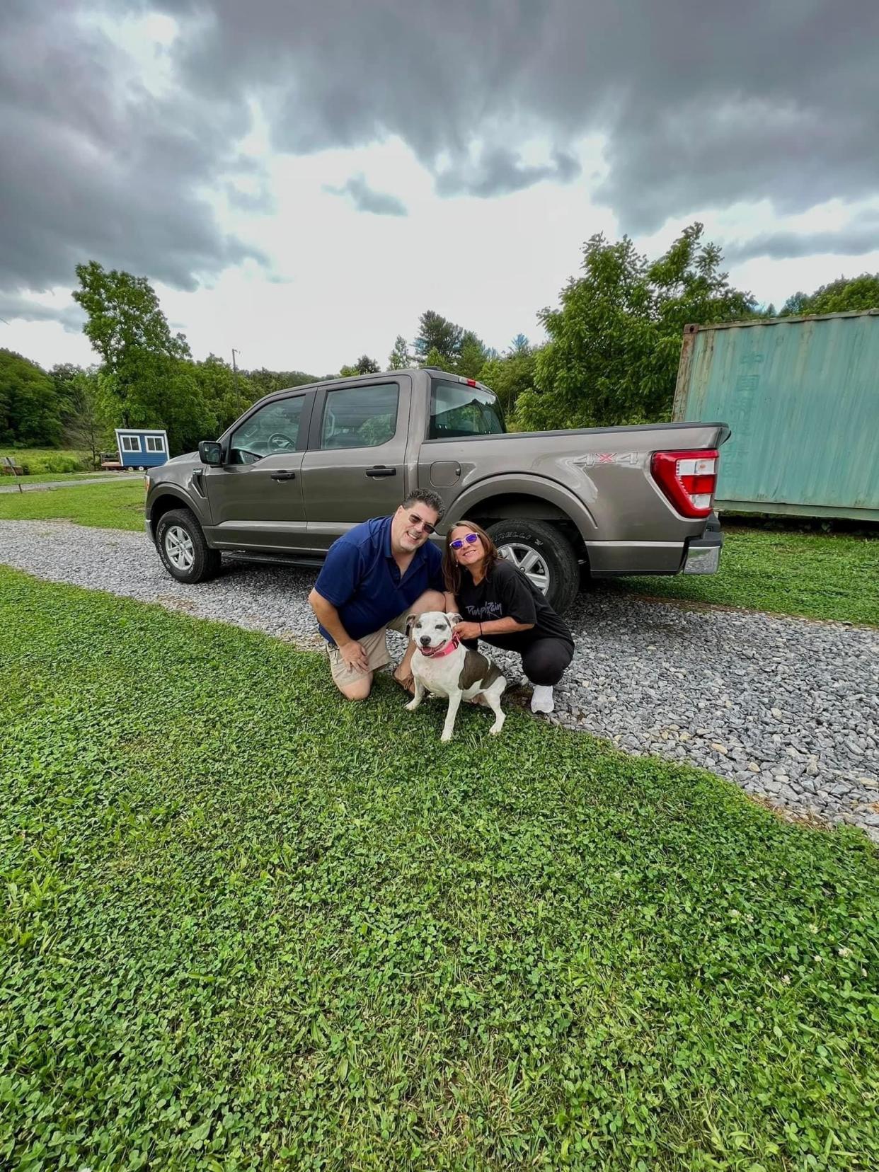 Steffie sits with her owners Paula Oppedisano-Pinkerton and Stuart Pinkerton.