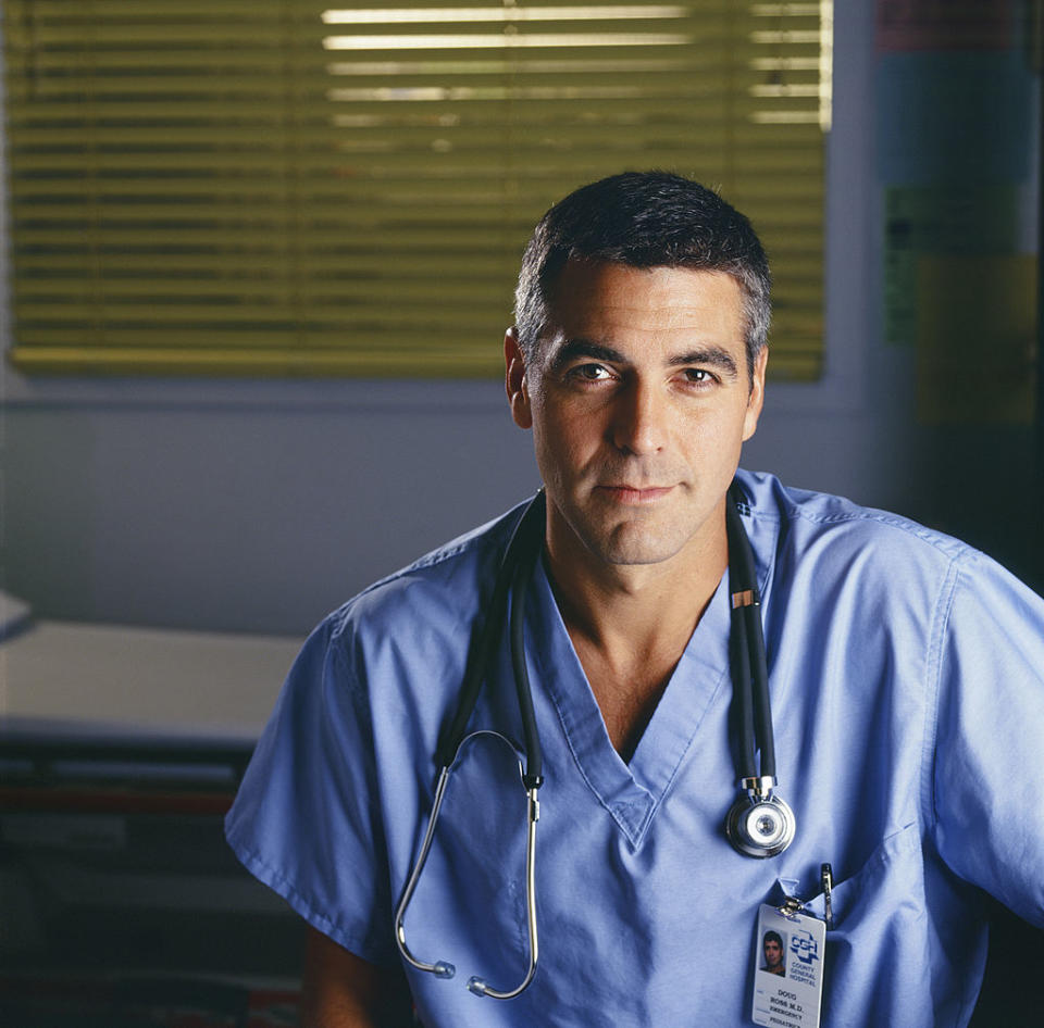 Close-up of George smiling in a role as a doctor