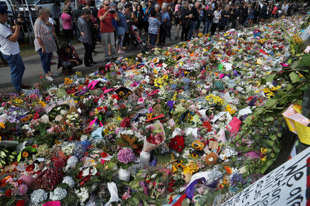 People visit a memorial site for victims of Friday's shooting, in front of Christchurch Botanic Gardens in Christchurch, New Zealand March 19, 2019. REUTERS/Jorge Silva