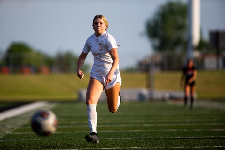 East's Macie Moore chases down the ball Tuesday, May 30, 2023, at Thornapple Kellogg High School.