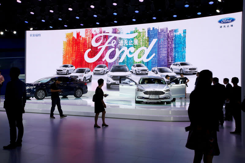 FILE PHOTO: Visitors look at Ford models at Auto Guangzhou in Guangzhou, China November 17, 2017. REUTERS/Bobby Yip/File Photo