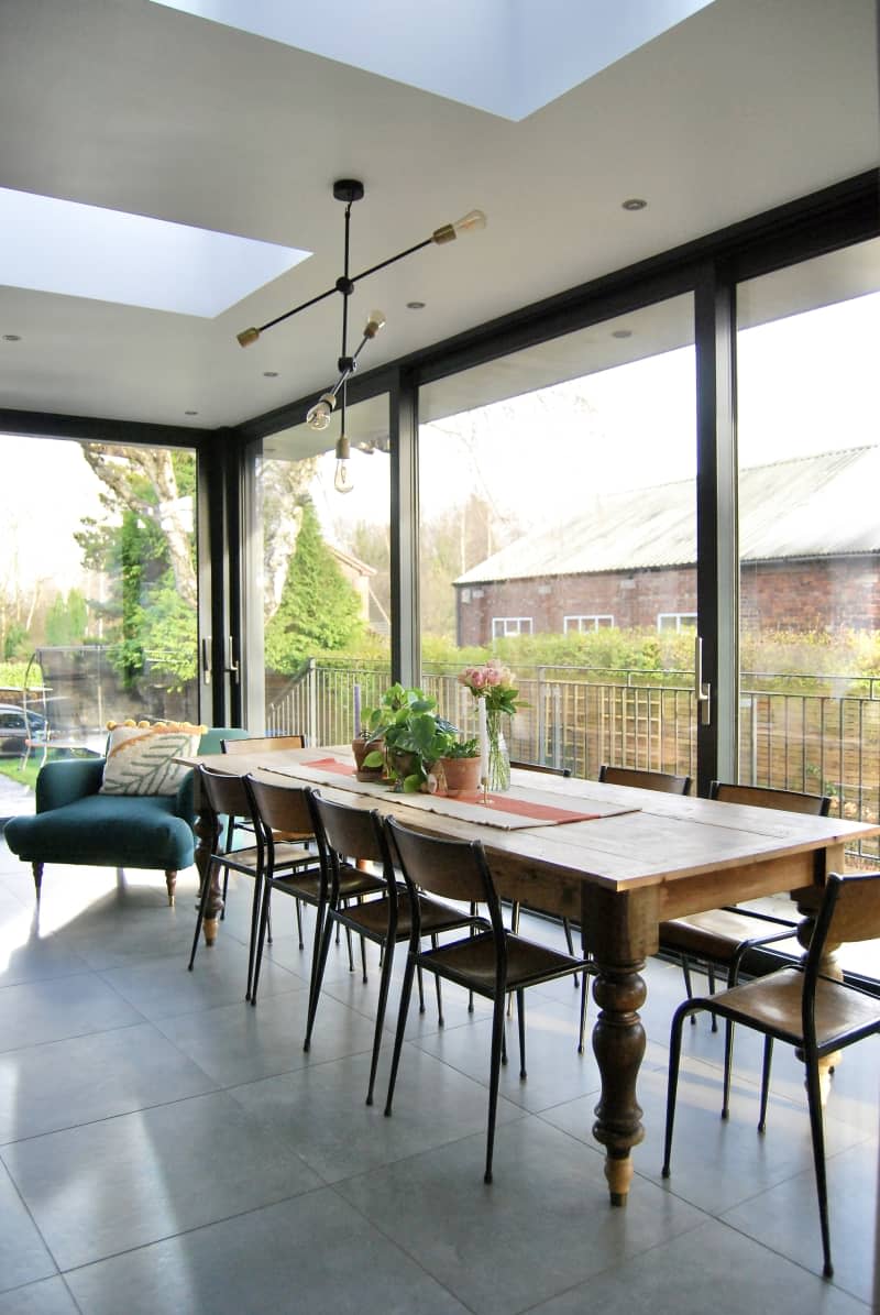 Long dining wooden below two large skylights