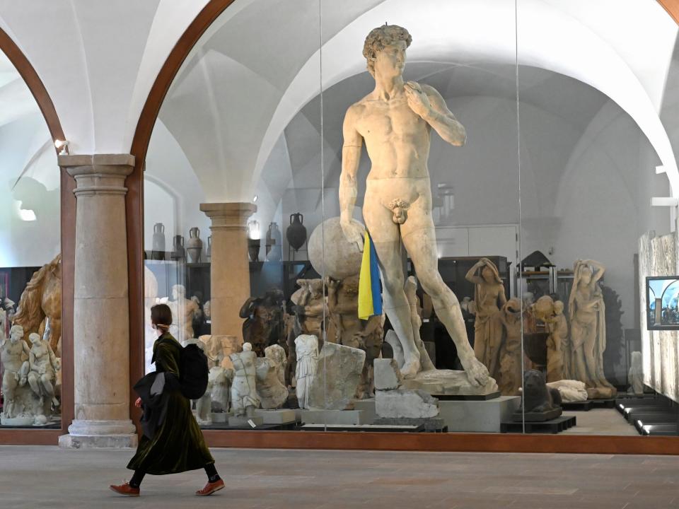 A Ukrainian flag is put in the hand of the Michelangelo's David cast, amid Russia's ongoing invasion of Ukraine, at the entrance area to the sculpture collection of the State Art Collections in Dresden, Germany, April 12, 2022