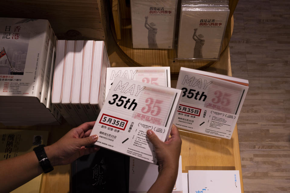 A customer browses Chong Mui Ngam's "May 35" play at an independent bookstore in Hong Kong, Friday, June 2, 2023. As the 34th anniversary of China’s Tiananmen Square crackdown approaches Sunday, June 4, many in Hong Kong are trying to mark the day in their own ways in the shadow of a law that prosecuted many leading activists in the city’s pro-democracy movement. (AP Photo/Louise Delmotte)