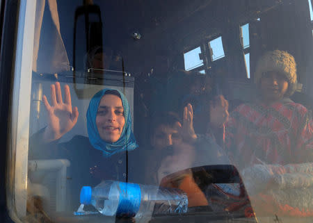 People who just fled a village controlled by Islamic State fighters wave from inside a bus before heading to the camp at Hammam Ali south of Mosul, Iraq February 22, 2017. REUTERS/Zohra Bensemra