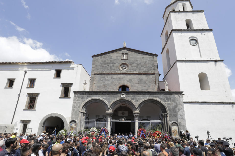 People attend the funeral of Carabinieri's officer Mario Cerciello Rega in his hometown of Somma Vesuviana, near Naples, southern Italy, Monday, July 29, 2019. Two American teenagers were jailed in Rome on Saturday as authorities investigate their alleged roles in the fatal stabbing of the Italian police officer on a street near their hotel. (AP Photo/Andrew Medichini)