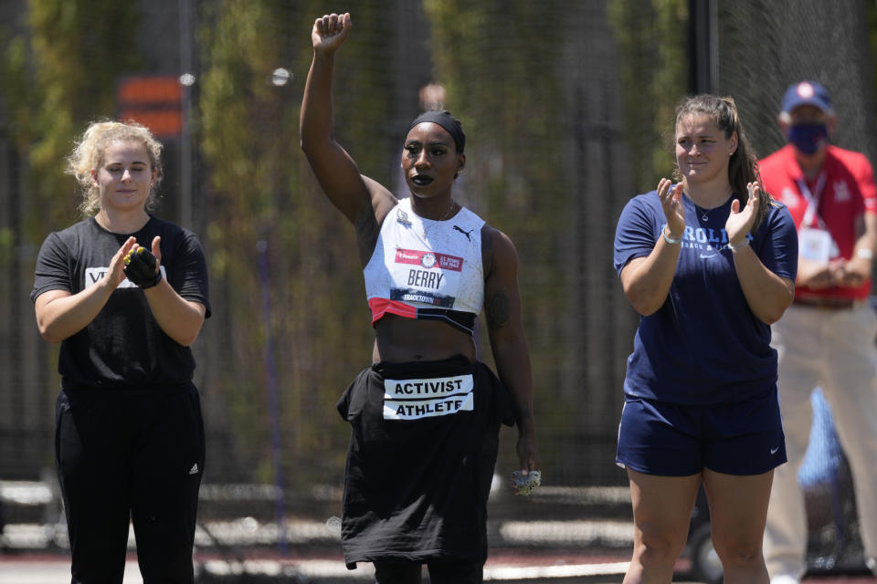Gwendolyn Berry lifts her arm during introductions for the prelims of the women's hammer throw at the U.S. Olympic Track and Field Trials Thursday, June 24, 2021, in Eugene, Ore. (AP Photo/Ashley Landis)
