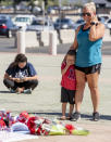 An emotional Amanda Wojciechowski, right, and her son Mason, 4, drove from Long Beach to visit a memorial for Angel pitcher Tyler Skaggs outside Angel Stadium in Anaheim on Monday, July 1, 2019. Tyler Skaggs died in Texas at the age of 27. (Photo by Leonard Ortiz/MediaNews Group/Orange County Register via Getty Images)