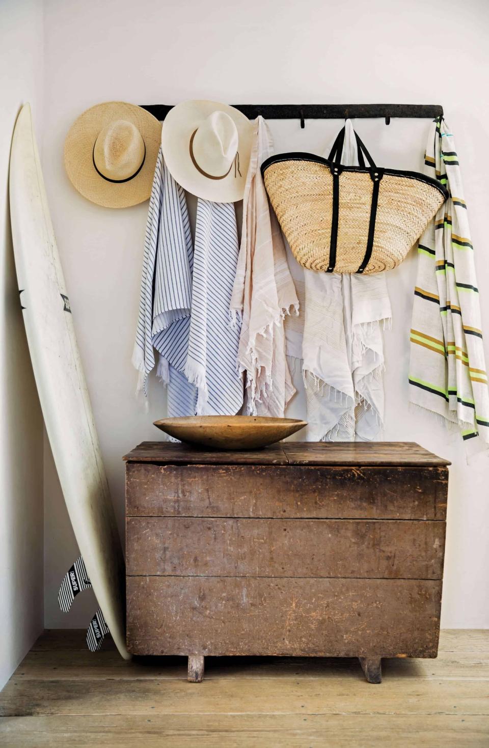 Coarse textiles and a rustic set of hallway drawers bring splashes of texture to this California Cool interior.