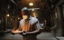 A Sri Lankan ethnic Tamil Hindu devotee performs religious rituals at a temple on New Year's day in Colombo, Sri Lanka, Friday, Jan. 1, 2021. (AP Photo/Eranga Jayawardena)