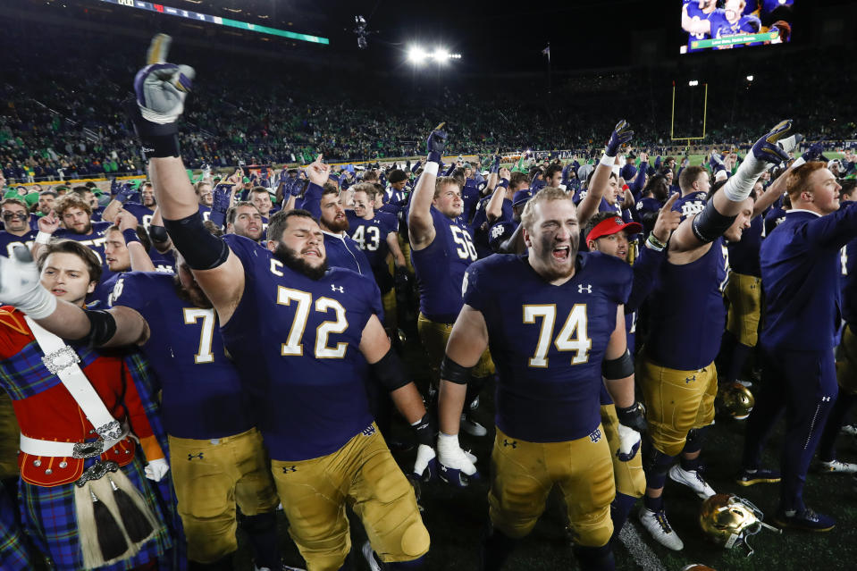 Notre Dame offensive linemen Robert Hainsey (72) and Liam Eichenberg (74) celebrate after defeating Southern California in an NCAA college football game in South Bend, Ind., Saturday, Oct. 12, 2019. (AP Photo/Paul Sancya)