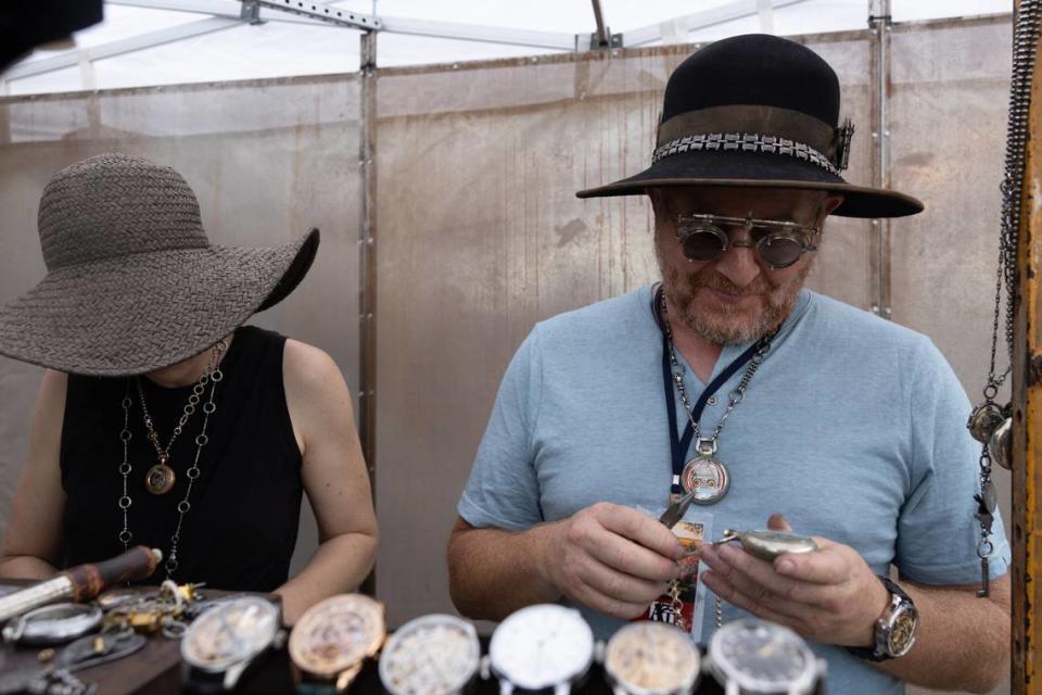 Jewelry maker Carlos Montenaro of Indio, Calif., inspects his wares during Belleville’s Art on the Square on May 18, 2024.