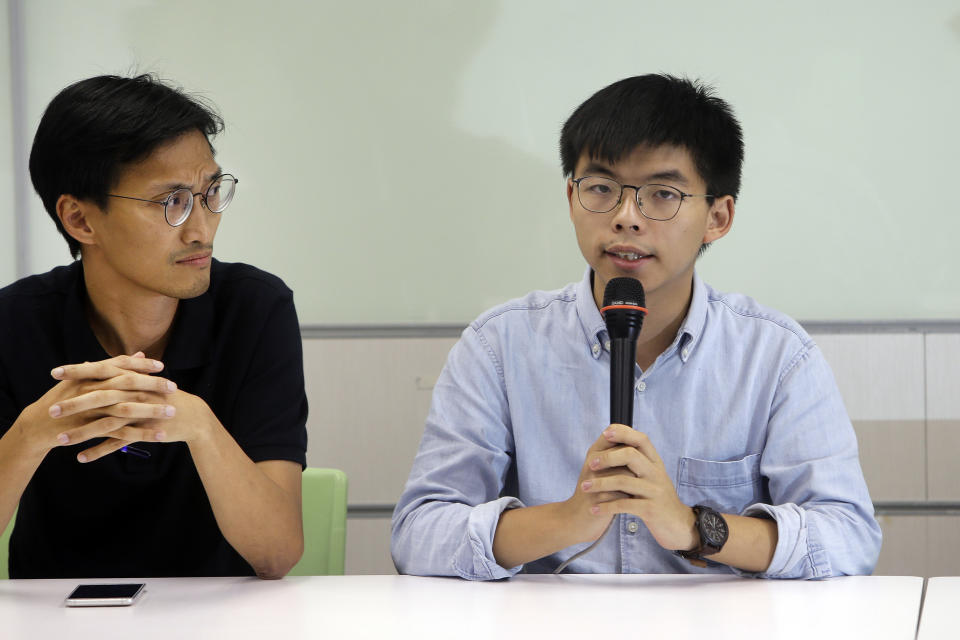 Hong Kong activist Joshua Wong, right, answers to the press after meeting with Taiwan Democratic Progressive Party (DPP) political leaders in Taipei, Taiwan, Tuesday, Sept. 3, 2019. Joshua Wong visited pro-democracy political leaders and joint forum during a two-days trip from Tuesday in Taiwan. (AP Photo/ Chiang Ying-ying)