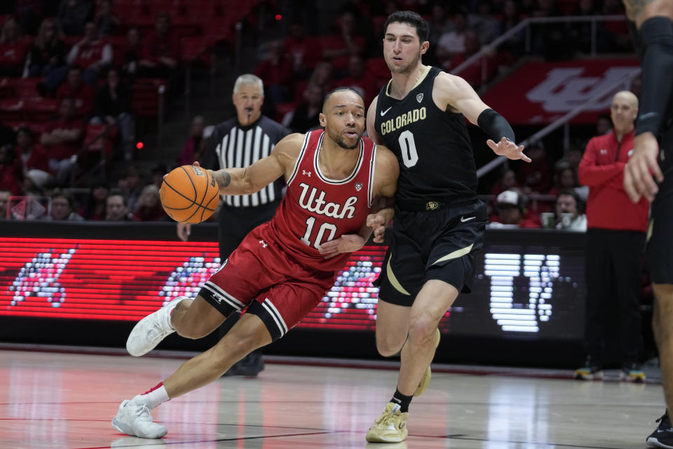 Utah guard Marco Anthony (10) drives as Colorado guard Luke O'Brien (0) defends during the second half of an NCAA college basketball game Saturday, Feb. 11, 2023, in Salt Lake City. (AP Photo/Rick Bowmer)