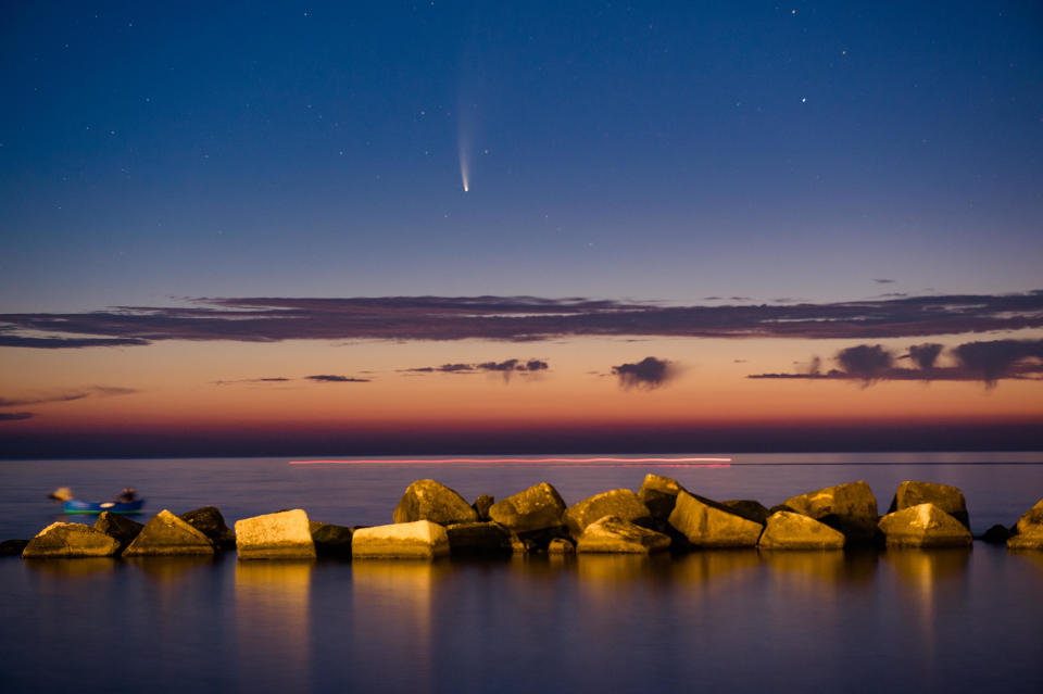 Comet Neowise shining at sunset above the Port of Molfetta in Molfetta on July 11, 2020. / Credit: Davide Pischettola/NurPhoto via Getty Image