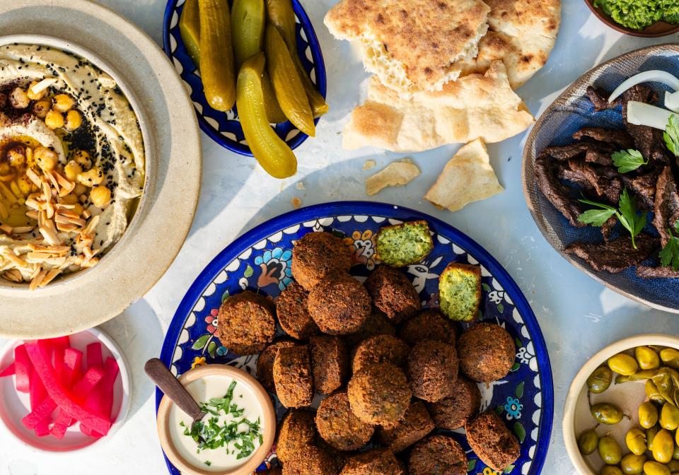 Ingredients for Kattan's Palestinian shawarma include falafel or meat, pickles, hummus, tahini, and pita.