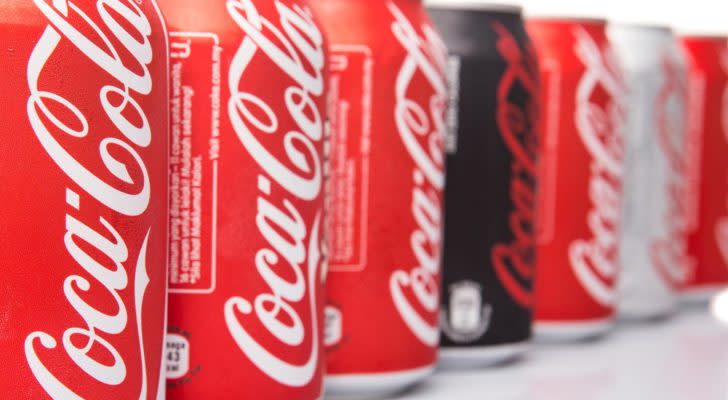 a line of Coca-Cola (KO) cans