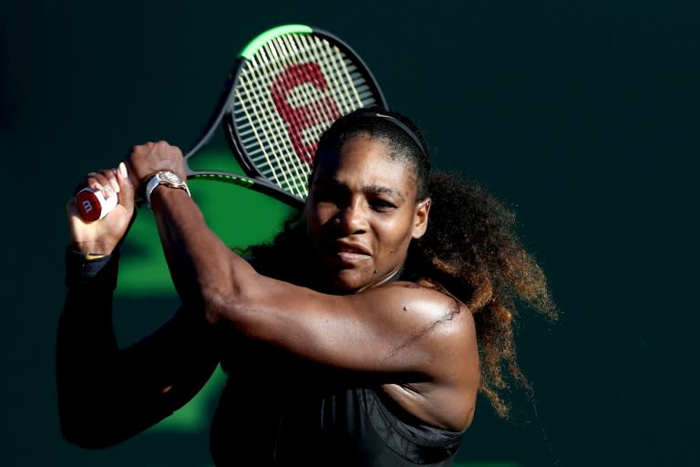 Serena Williams returns a shot to Naomi Osaka of Japan during the Miami Open Presented by Itau at Crandon Park Tennis Center on March 21, 2018 in Key Biscayne, Florida