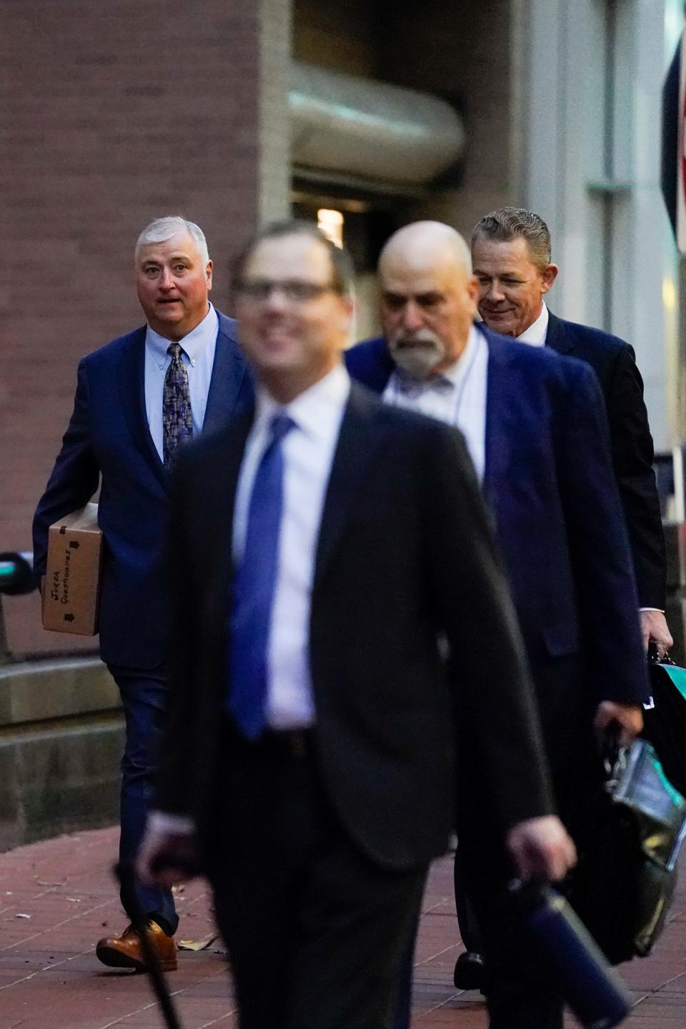 Former Ohio House Speaker Larry Householder, left, walks toward Potter Stewart U.S. Courthouse with his defense team before jury selection in his federal trial, Friday, Jan. 20, 2023,