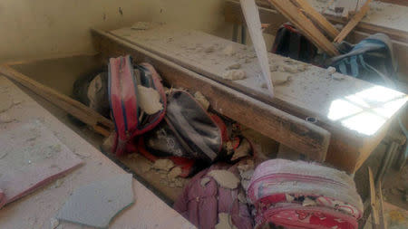 Students' bags are seen amid the debris of a damaged classroom after shelling by Syrian rebels on government-held western Aleppo, Syria in this handout picture provided by SANA on November 20, 2016. SANA/Handout via