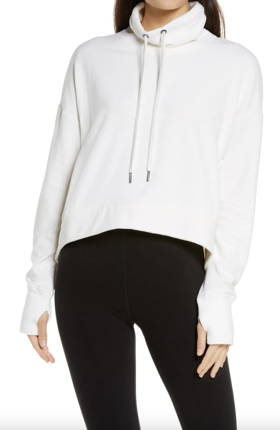 woman in black leggings and white hoodie, Sweaty Betty Harmonise Luxe Sweatshirt in Flint White (Photo via Nordstrom)