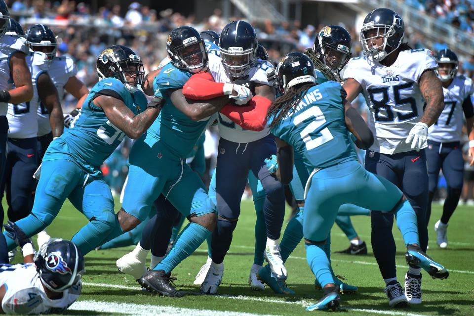 Tennessee Titans running back Derrick Henry (22) punches through the Jaguars defense for an early second quarter touchdown. The Jacksonville Jaguars hosted the Tennessee Titans at TIAA Bank Field in Jacksonville, Florida, October 10, 2021.  The Jaguars trailed at the half 24 to 13. [Bob Self/Florida Times-Union]