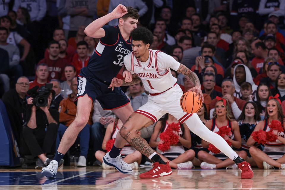 Nov 19, 2023; New York, New York, USA; Indiana Hoosiers center Kel'el Ware (1) dribbles against Connecticut Huskies center Donovan Clingan (32) during the first half at Madison Square Garden.