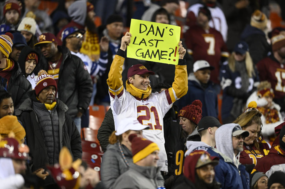 A Washington Commanders fans holds a sign aloft during the last season's finale between the Washington Commanders and the Dallas Cowboys at FedEx Field. (Photo by John McDonnell/The Washington Post via Getty Images)