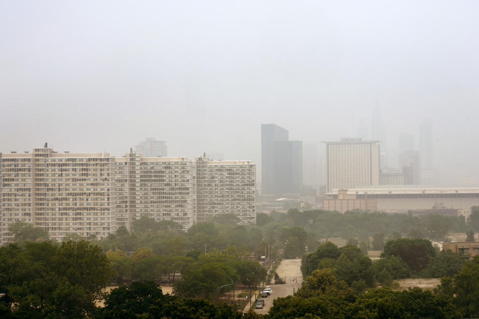 The Prairie Shores apartment complex, left, the Marriott Marquis, center, and the Hyatt Regency McCormick Place, right, stand above The McCormick Place Convention Center in a veil of haze from Canadian wildfires obscuring the majestic Chicago skyline, as seen from the city's Bronzeville neighborhood Tuesday, June 27, 2023, in Chicago. (AP Photo/Charles Rex Arbogast)
