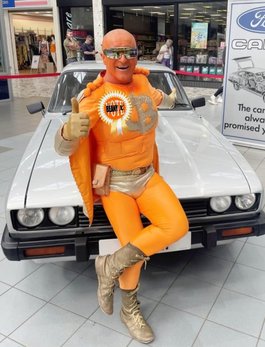 Captain Beany posing in front of a vintage car