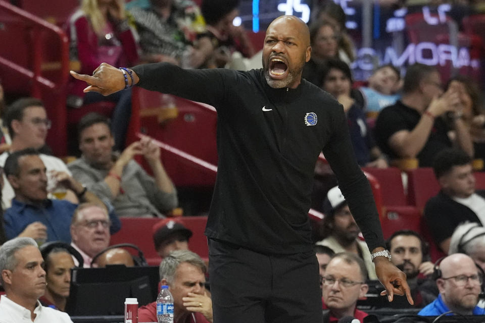 Orlando Magic head coach Jamahl Mosley gestures during the first half of an NBA basketball game against the Miami Heat, Friday, Jan. 12, 2024, in Miami. (AP Photo/Marta Lavandier)