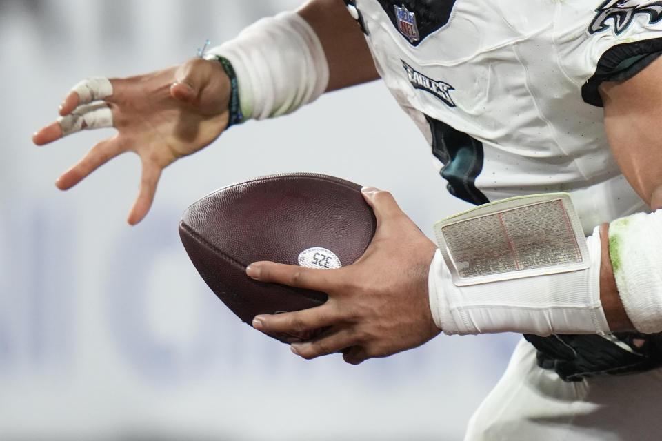 The hands of Philadelphia Eagles quarterback Jalen Hurts are seen as he is sacked for a safety in the end zone by Tampa Bay Buccaneers linebacker Anthony Nelson during the second half of an NFL wild-card playoff football game, Monday, Jan. 15, 2024, in Tampa, Fla. (AP Photo/Chris O'Meara)