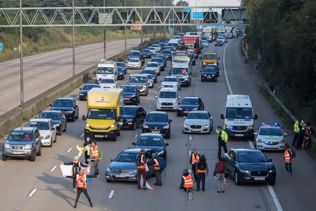 <strong>Insulate Britain climate activists begin to block the anticlockwise carriageway of the M25 between Junctions 9 and 10 as part of a campaign intended to push the UK government to make significant legislative change to start lowering emissions.</strong> (Photo: Mark Kerrison via Getty Images)