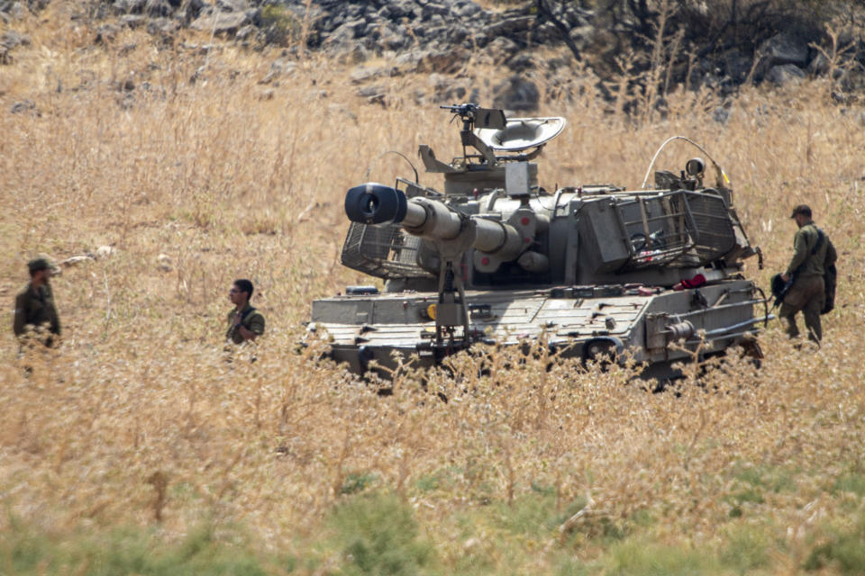 Israeli soldiers stand next to an Israeli mobile artillery unit placed in northern Israel near the border with Lebanon, Tuesday, July 28, 2020. The Israeli military on Monday said it thwarted an infiltration attempt by Hezbollah militants — setting off one of the heaviest exchanges of fire along the volatile Israel-Lebanon frontier since a 2006 war between the bitter enemies. (AP Photo/Ariel Schalit)