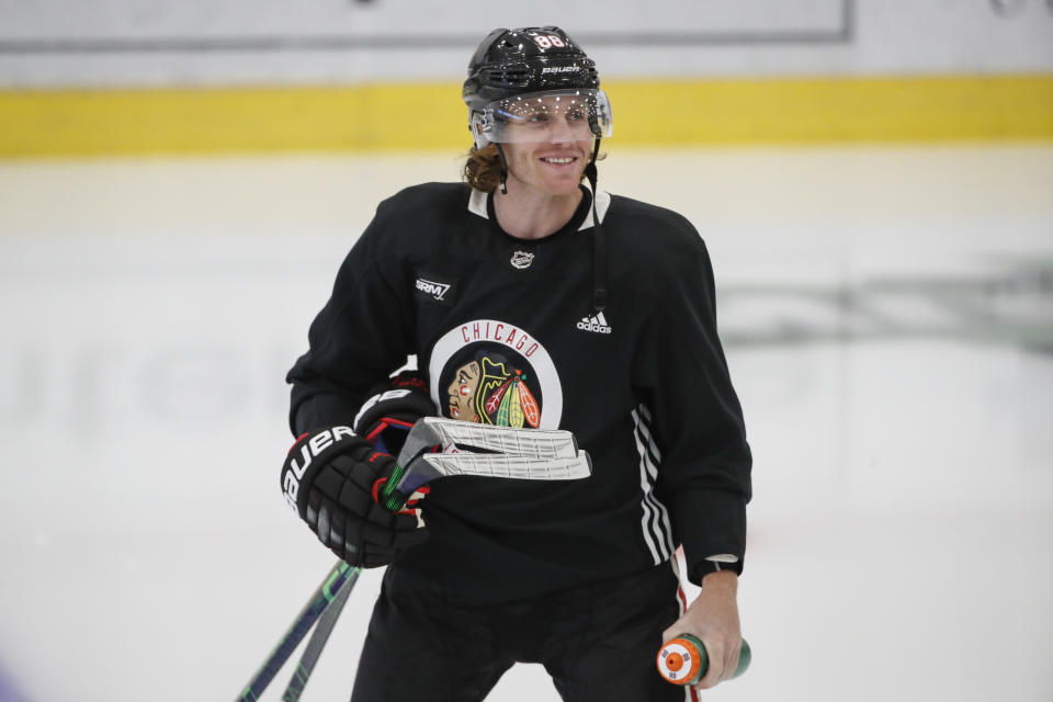 Chicago Blackhawks right wing Patrick Kane, smiles as he takes the ice for NHL hockey practice at Fifth Third Arena on Monday, July 13, 2020, in Chicago. (AP Photo/Kamil Krzaczynski)