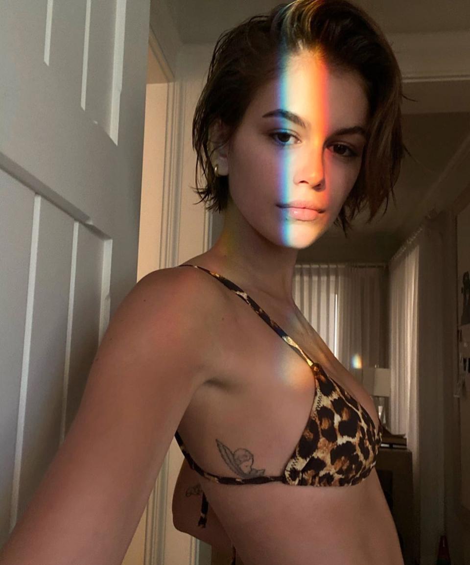 Kaia Gerber poses in a leopard print bikini