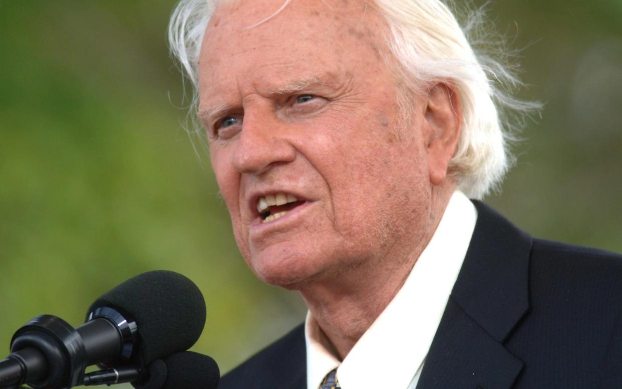 The Rev Billy Graham speaks on stage on the third and last day of his farewell American revival in the Queens borough of New York, in June 2005 - AP