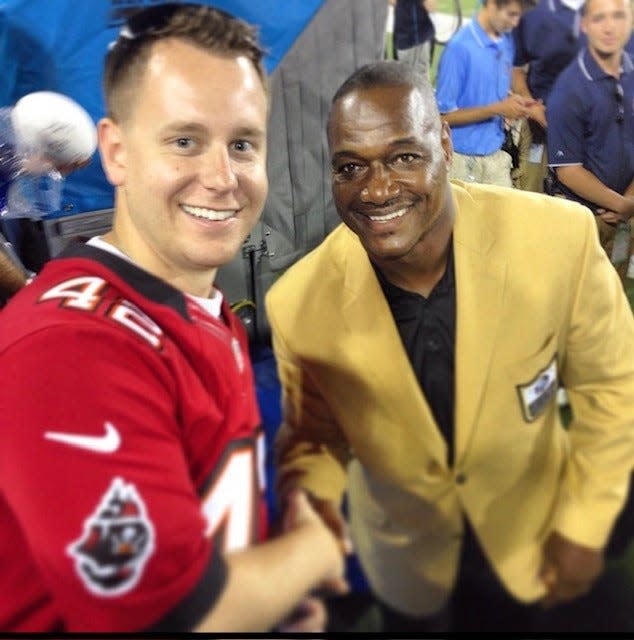Richie Williams shakes hands with Hall of Famer Derrick Brooks during the 2014 Hall of Fame Game.
