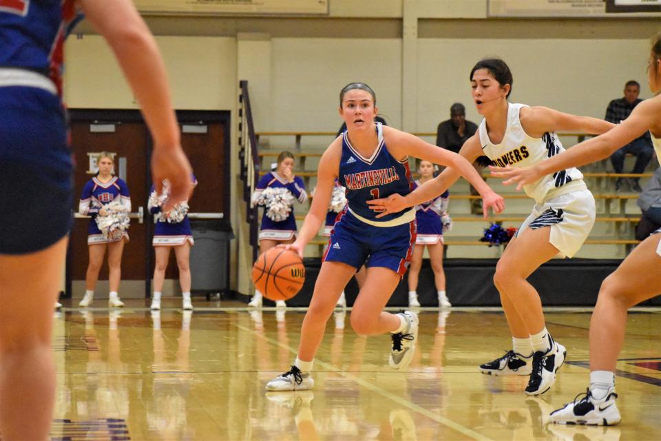Martinsville's Marina Rautenkranz (1) dribbles past Mooresville's Sydney Hardy during the Artesians' sectional matchup with rival Mooresville on Feb. 3, 2023.