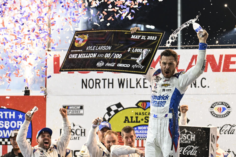 Kyle Larson (5) celebrates in Victory Lane after winning the NASCAR All-Star Cup Series auto race at North Wilkesboro Speedway, Sunday, May 21, 2023, in North Wilkesboro, N.C. (AP Photo/Matt Kelley)