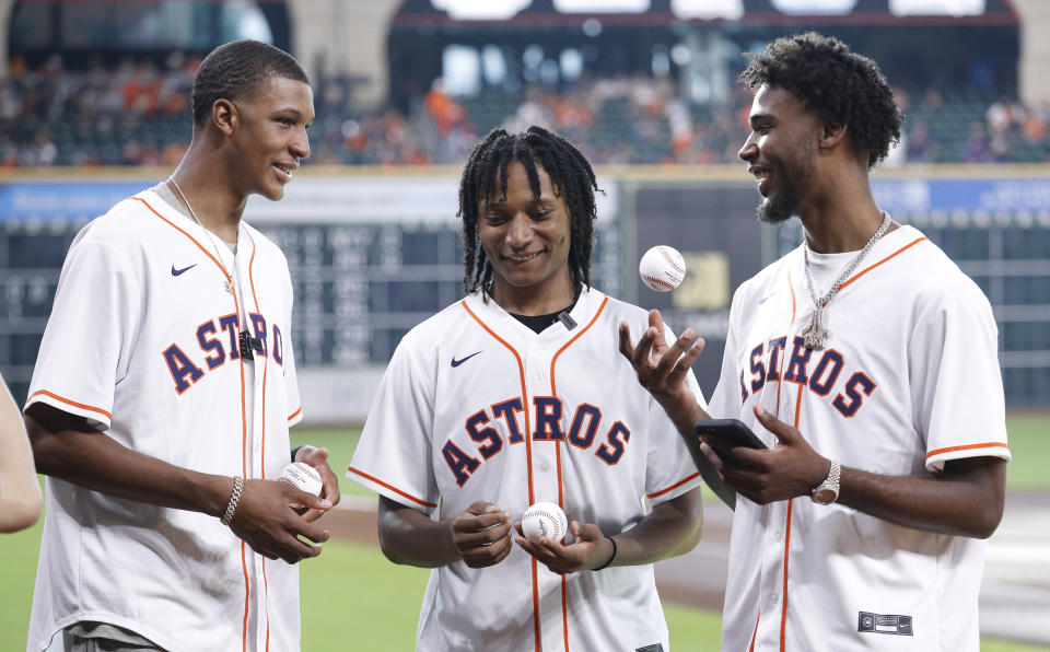 Houston Rockets draft picks Jabari Smith, TyTy Washington and Tari Eason talk before throwing out ceremonial first pitches before a baseball game between the Houston Astros and the Kansas City Royals on Tuesday, July 5, 2022, in Houston. (AP Photo/Kevin M. Cox)
